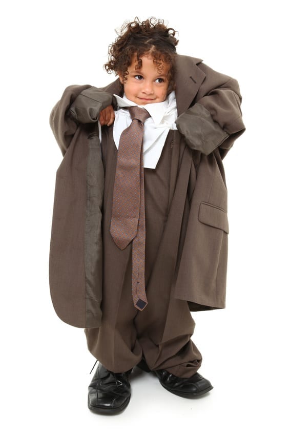 Small child in baggy suit