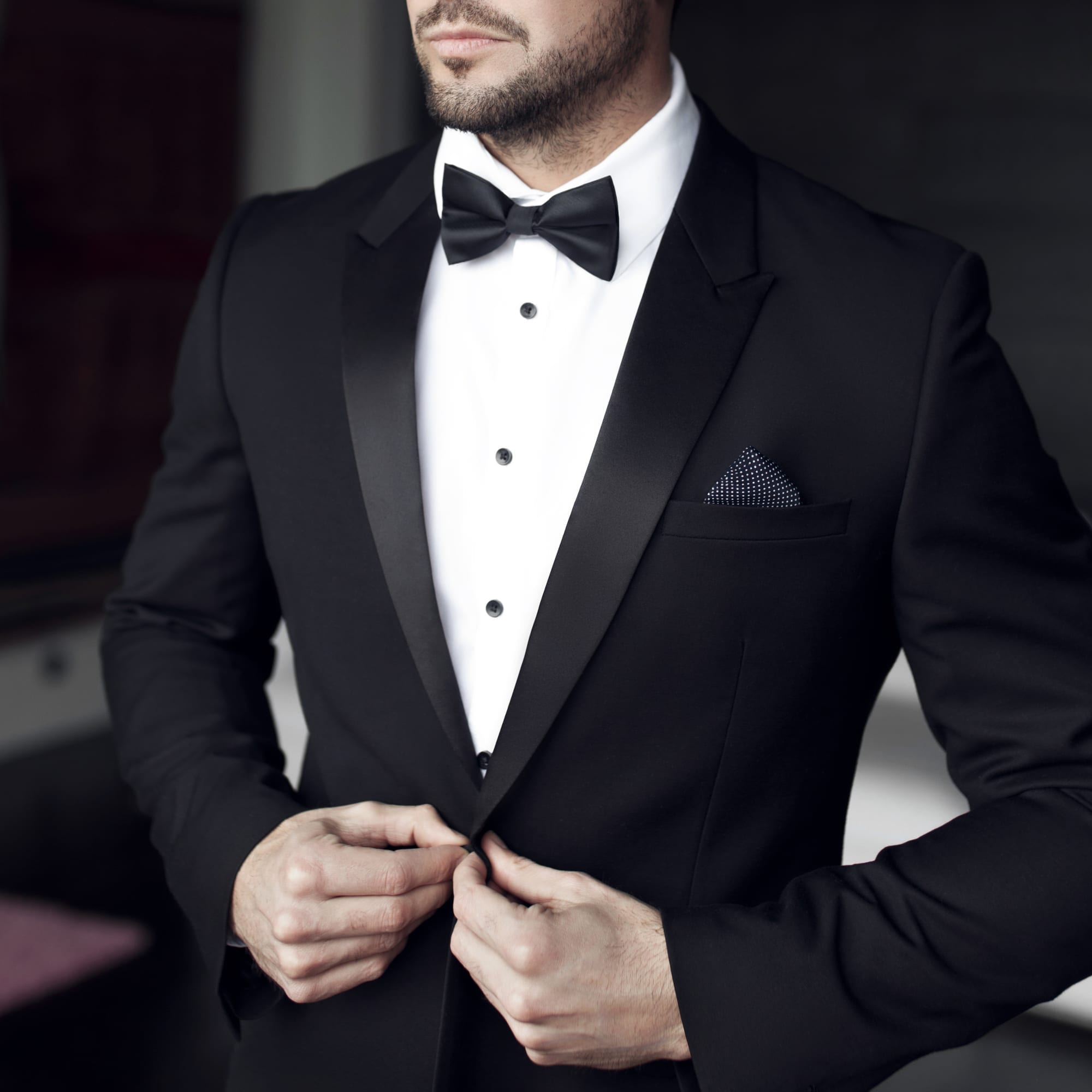 Man in tuxedo and bow tie showing black tie dress code