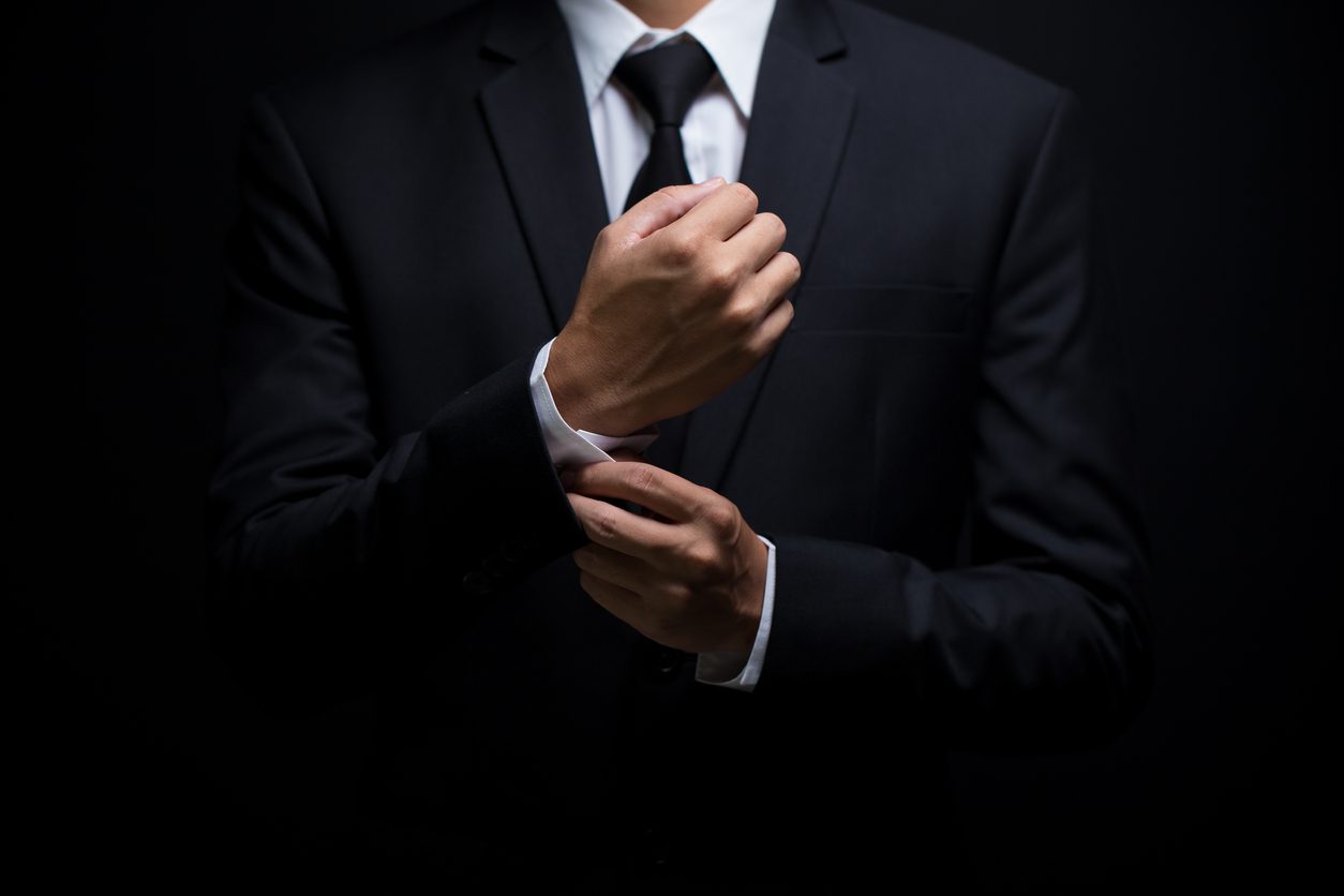businessman-adjusting-his-suits-cufflinks
