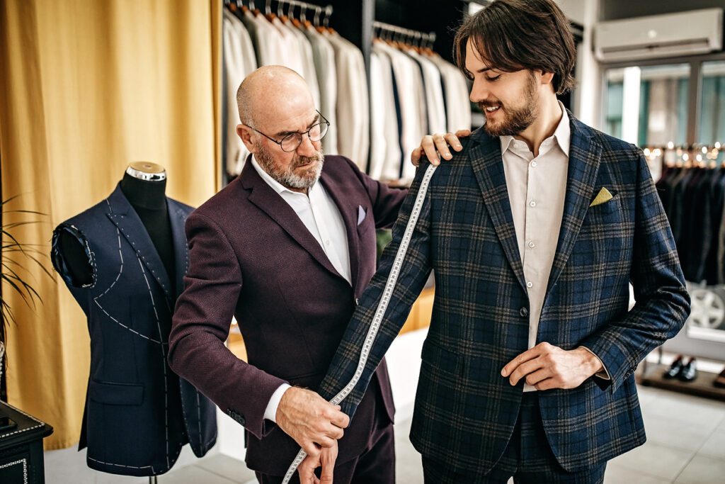 senior-tailor-measuring-customers-sleeve-custom-tailored-clothes-concept