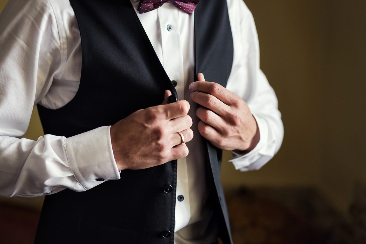 man-wearing-a-vest-getting-ready-for-a-ceremony