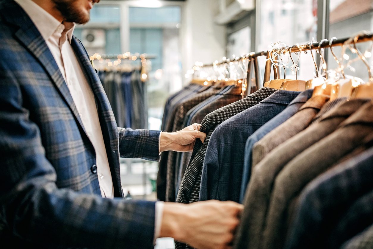 Man selecting clothes for an outdoor company retreat.