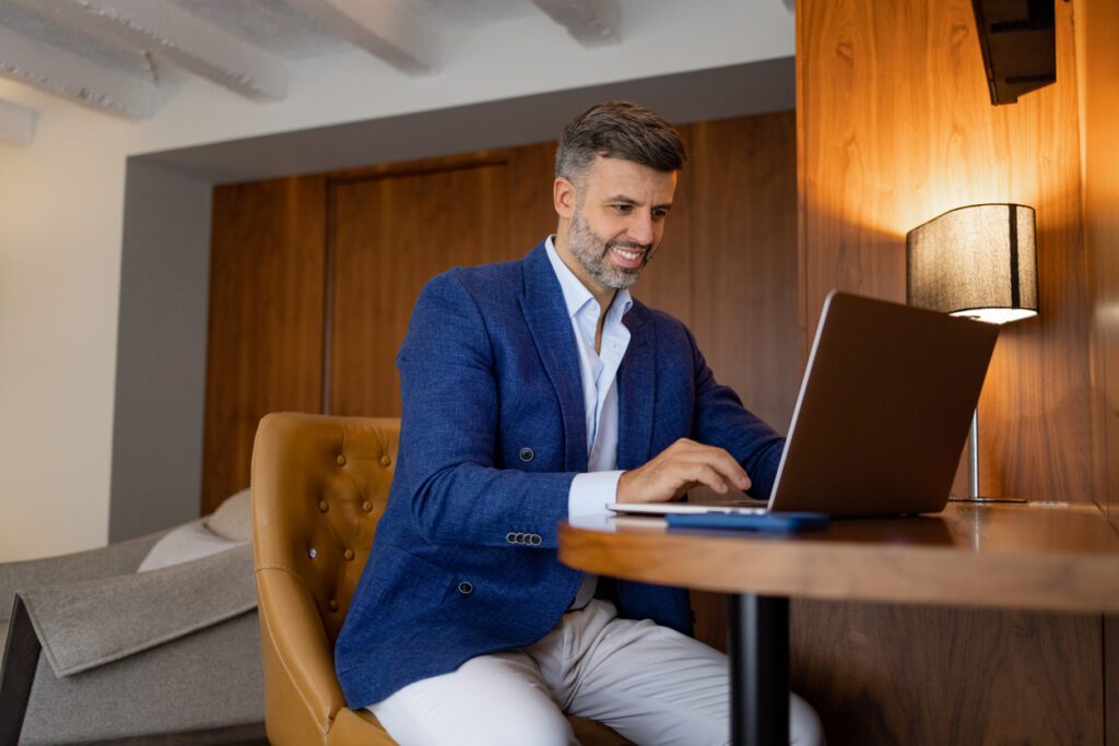 A man is wearing comfortable and professional work-from-home clothing while working from home.
