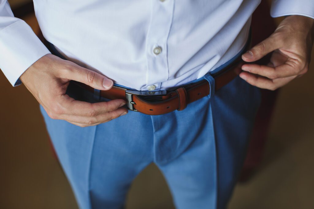 Man correcting his belt.