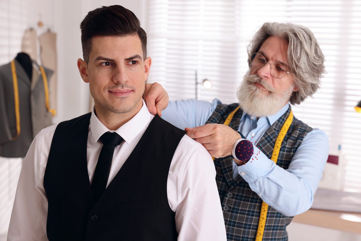 Professional tailor working with client to create a made-to-measure suit.