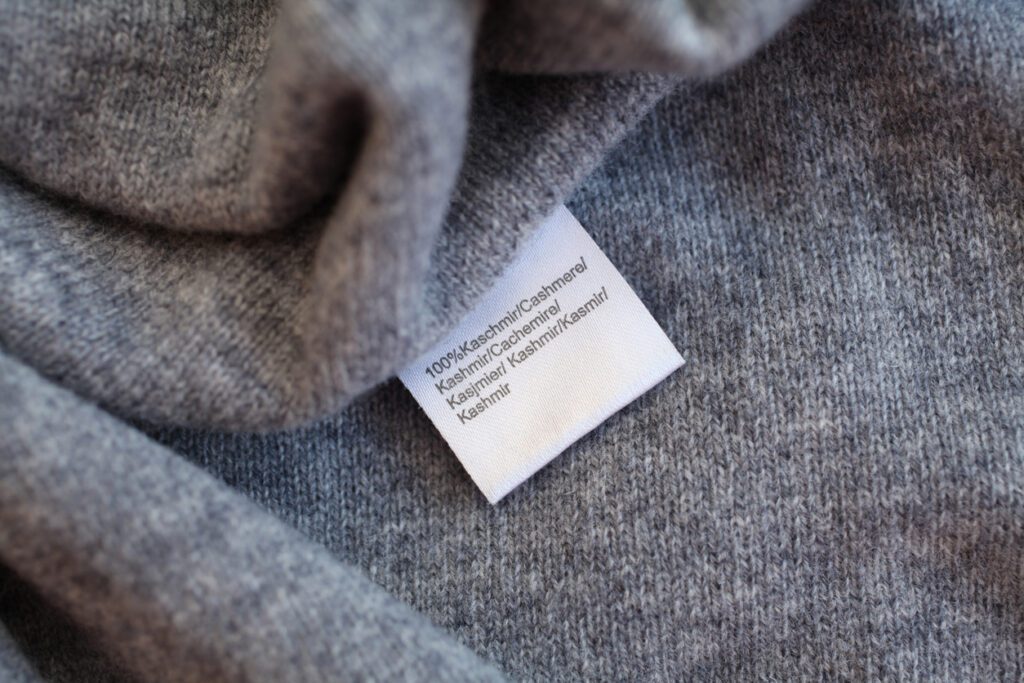 Grey, soft, cashmere garment with tag.